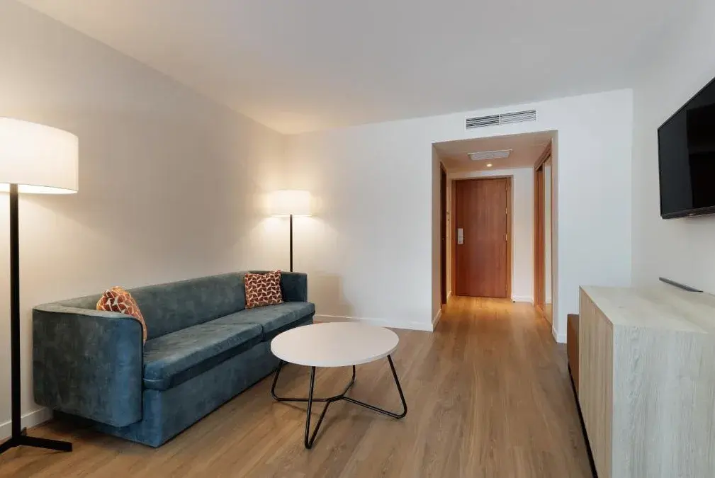 Suite living area with sofa at Exe Vienna Hotel